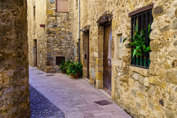 Medieval houses built of stone in narrow alleys in the tourist town of Besalu, Girona.