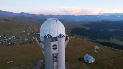 Two large telescope domes at sunset. Drone view of Assy-Turgen Observatory. Beautiful red sunset....