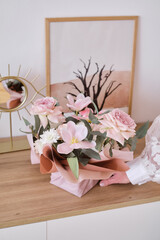Beautiful floral arrangement with delicate pink and white flowers. Gift bouquet on a wooden table in the room