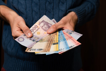 close-up on Hungarian forints held in hands. Hungarian economics and finance