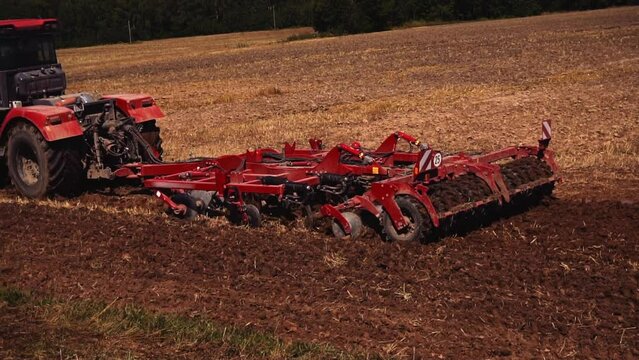 Tractor on land cultivating. Tractor with disk harrow