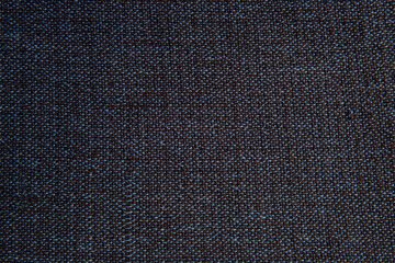 Fototapeta na wymiar top view, close up of woven fabric containing dark blue, light blue, and black; textile