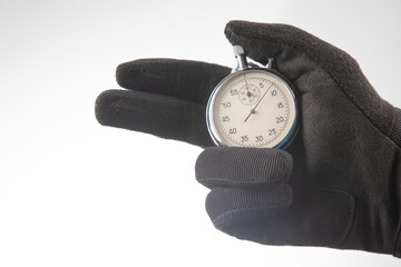 hand with a mechanical stopwatch on a white background.