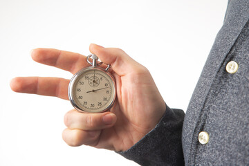 hand with a mechanical stopwatch on a white background.