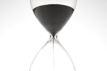 Hourglass on a light background. Time is money. Business solutions in time.