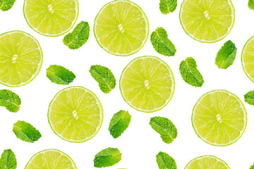Seamless pattern made of fresh raw green aromatic mint or peppermint herb leaves and juicy sour lime slices isolated on white background used for preparation of mojito cocktail or refreshing lemonade