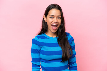 Young Colombian woman isolated on pink background with surprise facial expression