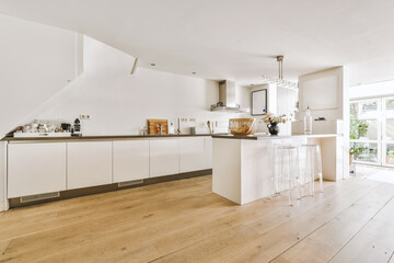 Modern minimalist style interior design of studio apartment with open white kitchen and dining zone...