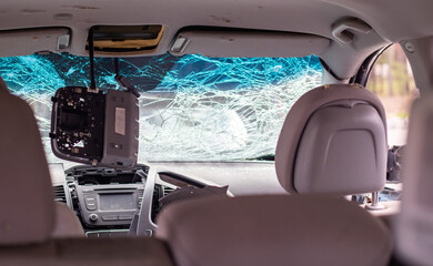 Damaged car window after an accident. Broken windshield as a result of an accident, inside view....