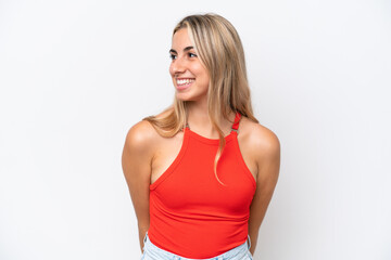 Fototapeta premium Young caucasian woman isolated on white background looking to the side and smiling