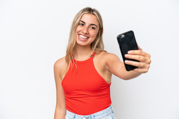 Fototapeta premium Young caucasian woman isolated on white background making a selfie