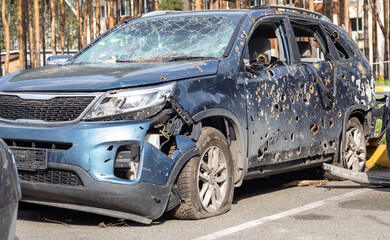 Car riddled with bullets. War of Russia against Ukraine. A car of civilians shot by the Russian military during the evacuation of women and children. Traces of bullets and fragments of shells.