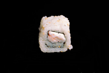 brazilian japanese food isolated on black background rice and kani sushi.