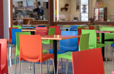 Colorful chairs and tables in the cafe.No people, empty interior