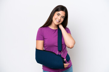 Young Brazilian woman with broken arm and wearing a sling isolated on white background laughing