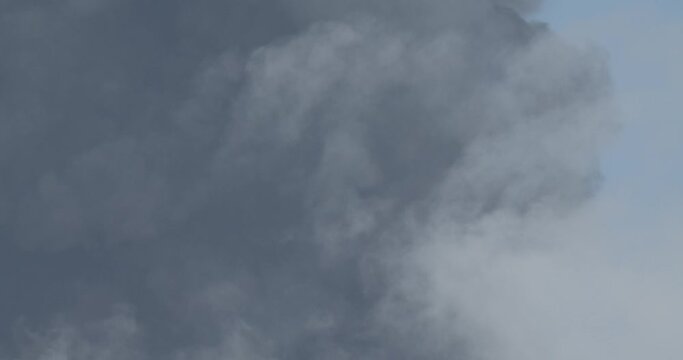 Details of volcanic ash billowing into the air during an explosive eruption