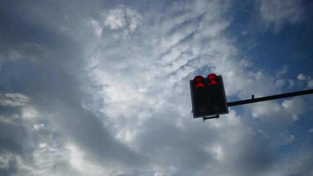 Red traffic light is changing to green and sky background