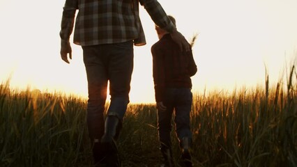 Farmer and his son in front of a sunset agricultural landscape. Man and a boy in a countryside field. Fatherhood, country life, farming and country lifestyle concept. - Powered by Adobe