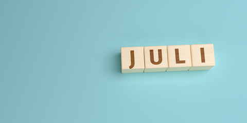The German word Juli (July) built from letters on wooden cubes. High angle view with copy space