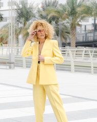 Urban style street fashion photosoot young model wearing yellow trendy suit