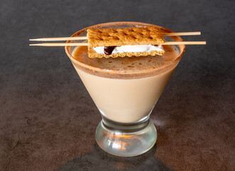 S'mores martini on a dark background with s'mores garnish