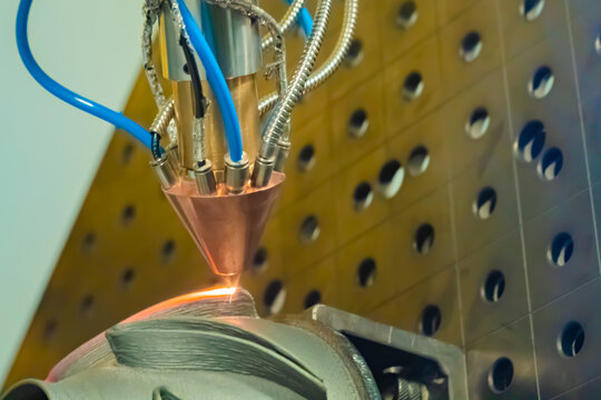 Direct metal deposition - advanced additive laser melting and powder spray manufacturing technology for repair, rebuild metal workpieces - close up. Metalworking, robotic, industrial concept