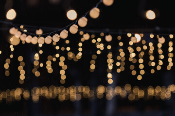 blurred lights of garlands and festive lighting. festive garlands in the park at night