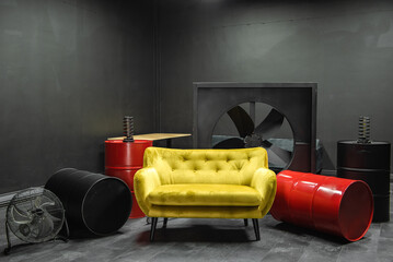 Yellow sofa in a black room in a dark interior