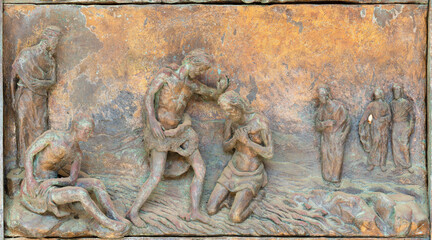 MONOPOLI, ITALY - MARCH 6, 2022: The bronze relief  Baptism of Jesus the  on the gate of church Chiesa di Sacro Cuore by Wolfgang Stempfele from year 2002.
