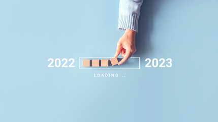 Loading new year 2022 to 2023 with hand putting wood cube in progress bar. Start new year 2023 with goal plan, goal concept, strategy. - obrazy, fototapety, plakaty