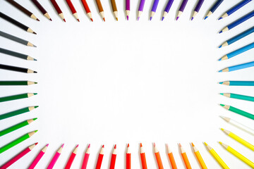 Rectangular frame of colored pencils on white paper, back to school, bright wooden pencils spread around the edges, around the perimeter of a white background, space for text