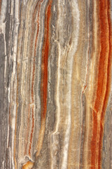 Cross-section of the rock. Multi-colored layers that form an abstract background. - 526379543