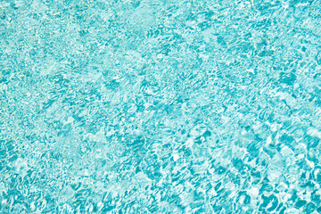 turquoise color background of swimming pool water with ripples in summer resort