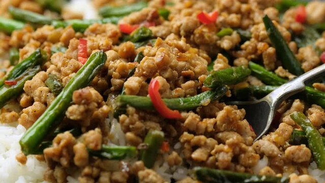 Eating Stir Fry Pork with Green Beans with tablespoon