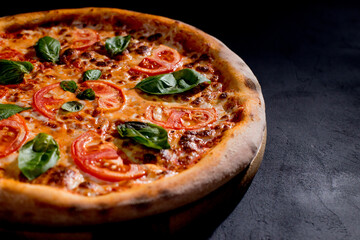Delicious fragrant pizza with mozzarella, tomatoes and basil with tomato sauce - Margherita