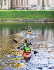A process of kayaking in the city river canals, with colorful canoe kayak boat paddling, process of canoeing, group of kayaks, colorful canoe kayak boat paddling, summer sunny day