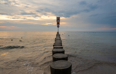 breakwater with warning sign