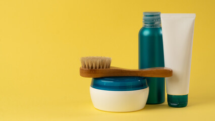 Fototapeta na wymiar A set of cosmetics for personal care - cream, serum, massage brush