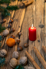 Traditional Czech Christmas on wood decoration with twig, candle, apple, orange, fruit