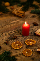 Traditional Czech Christmas on wood decoration with twig, candle, apple, orange, fruit
