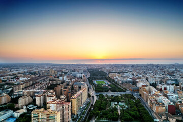 Fototapeta na wymiar Aerial drone view of sunrise over Turia Gardens, a riverbed turned into a park, in Valencia, Spain
