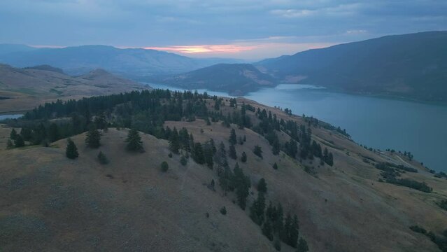 Aerial View of Canadian Landscape with Kalamalka Lake and Mountains. Colorful Cloudy Summer Sunrise. Near Vernon, Okanagan, BC, Canada. Nature Background.