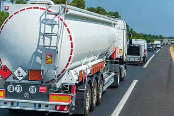 Fuel tanker truck in a retention on the highway with orange panels identifying the danger and...