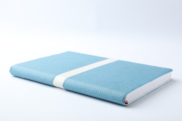 Stylish light blue notebook isolated on white