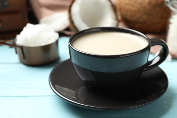 Delicious coffee with organic coconut oil on blue wooden table