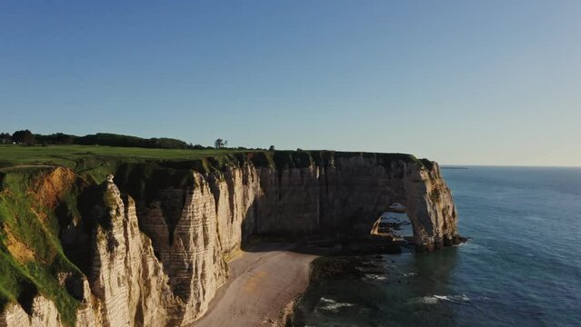 A general bird's-eye view of the picturesque coastal cliffs with bizarre green peaks and natural arches. Etretat, France