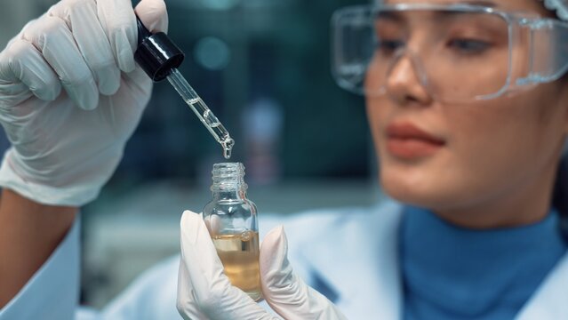 Scientist test CBD hemp oil product in curative CBD lab . The hemp oil contain natural cbd extraction from organic hemp in the farm .