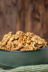 wallnut in ceramic bowl on green tablecloth in kitchen