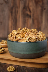 walnut in ceramic bowl on wooden tray in kiechen table