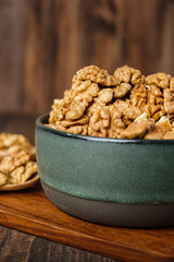 walnut in ceramic bowl on wooden tray in kiechen table